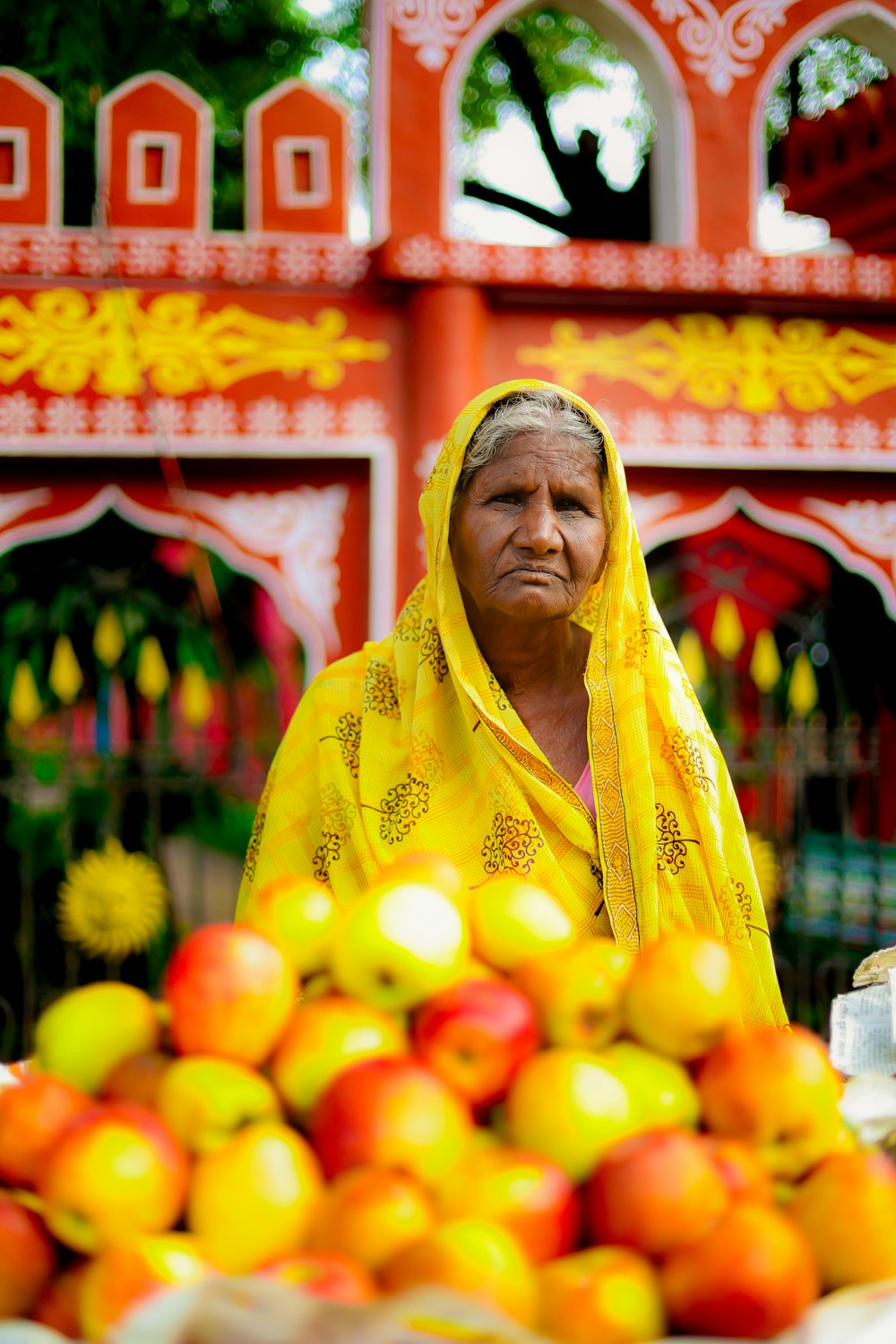 a man in a yellow robe in a fruit stand