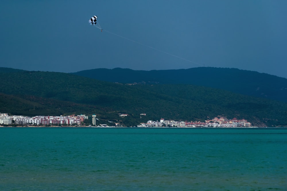 a person flying a kite over a body of water