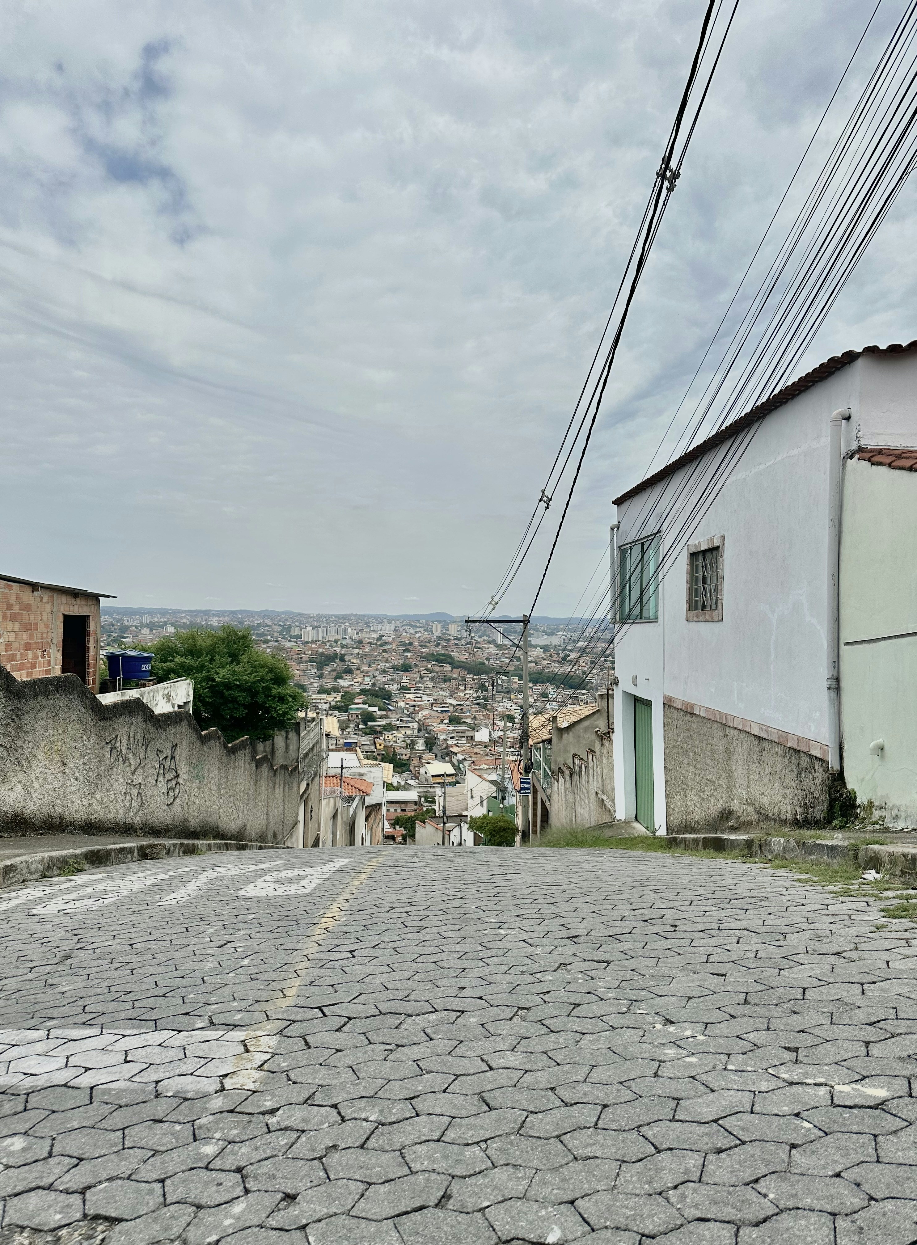 a stone road with buildings on either side of it