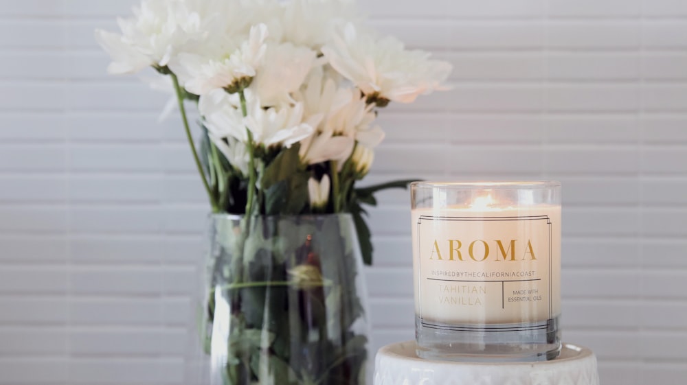 a glass jar with white flowers