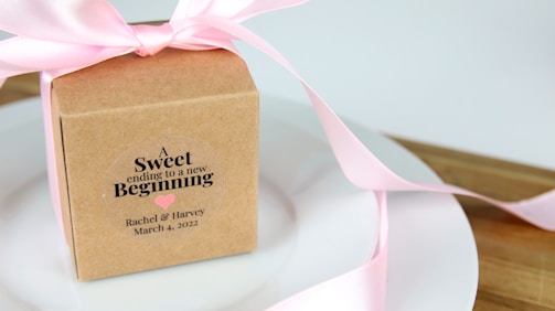 a pink ribbon tied around a box