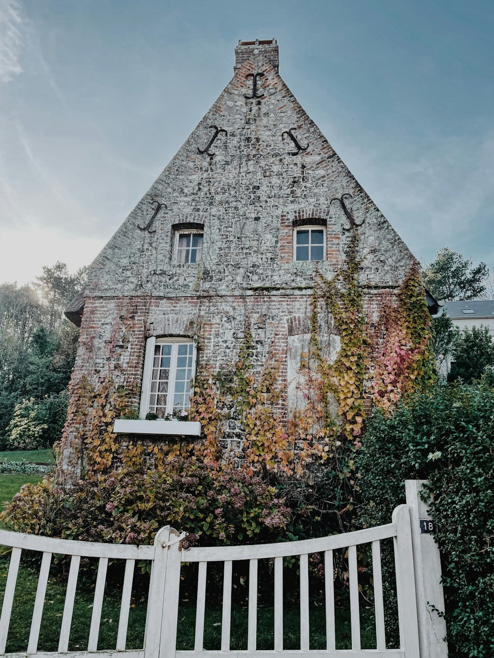 a stone building with a fence in front of it