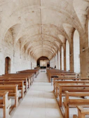 a large church with rows of wooden benches