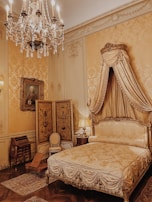 a bedroom with a bed and chandelier