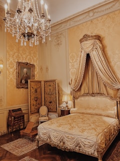 a bedroom with a bed and chandelier