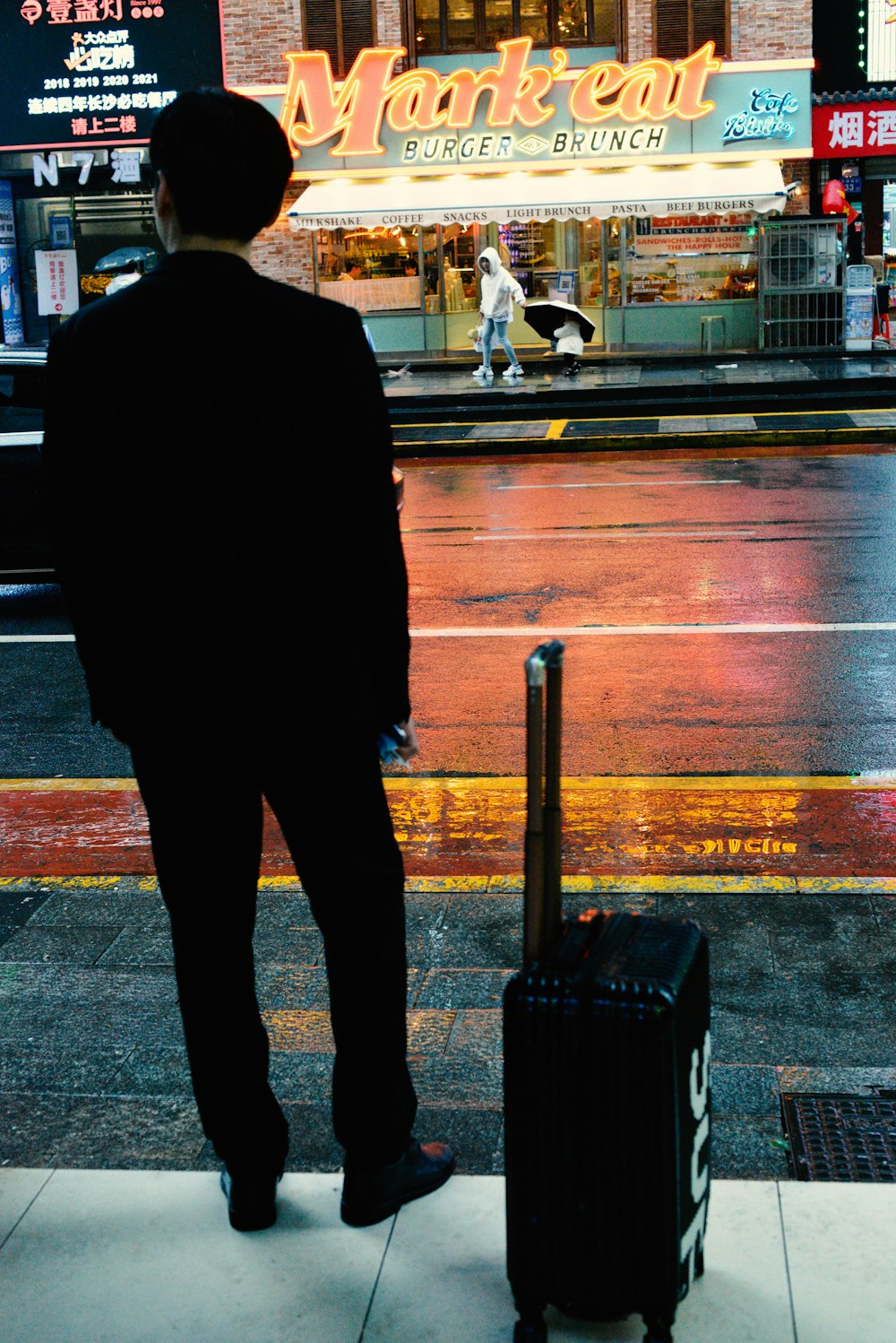 a man with a suitcase waiting for a bus