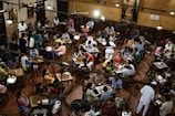 A vibrant café scene showing customers enjoying their meals, with subtle stayo branding on table tents.