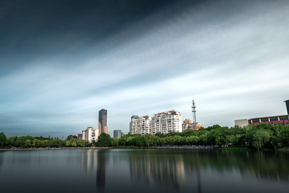 a body of water with buildings and trees around it