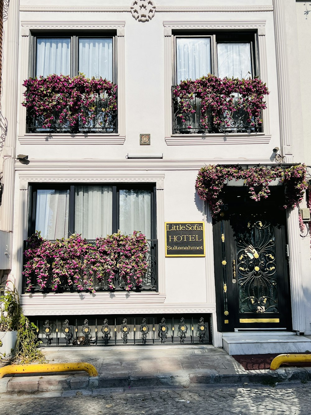 a building with flowers on the windows