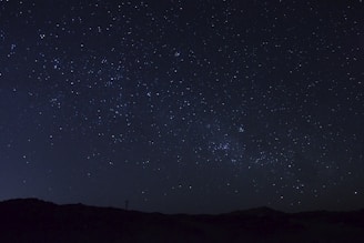 A night sky background with a film reel and stars shining bright.