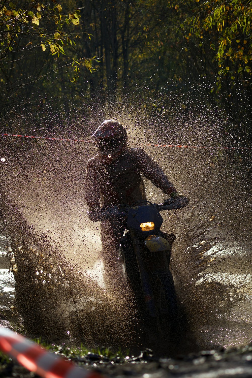 a person riding a motorcycle in the rain