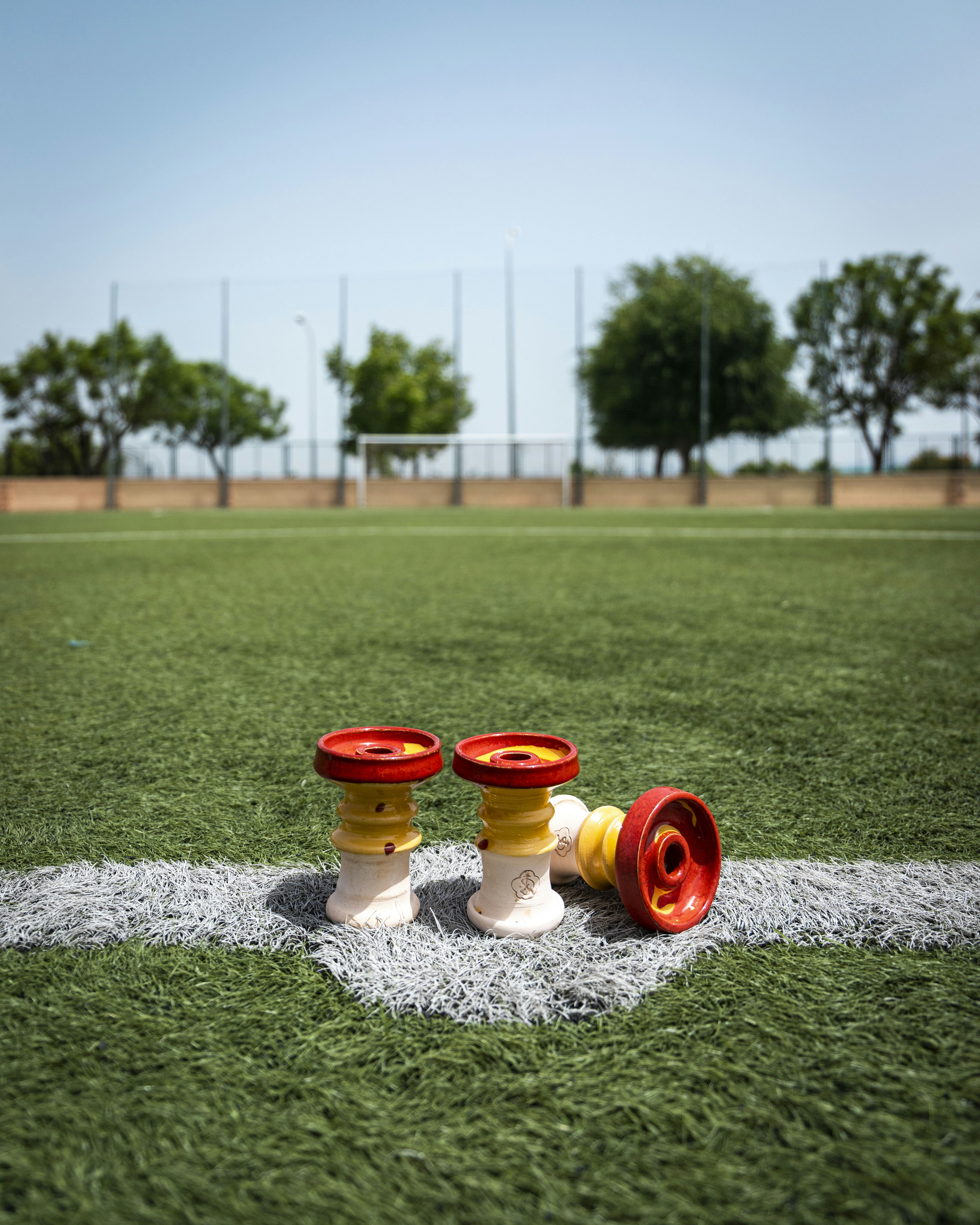 a group of small red and white wheels on a grass field