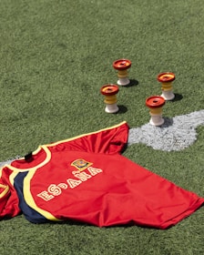 a red and yellow shirt on the grass