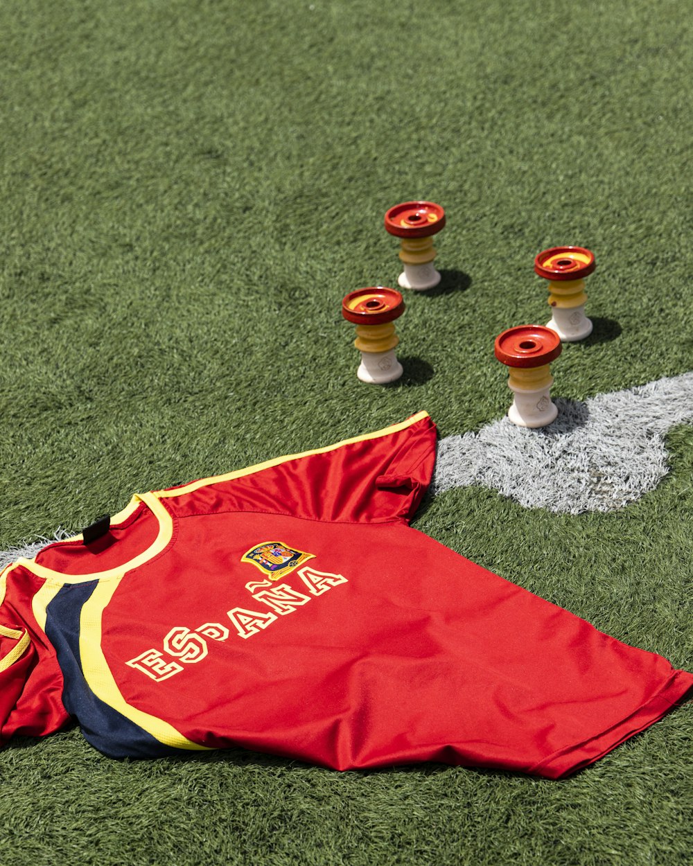 a red and yellow shirt on the grass