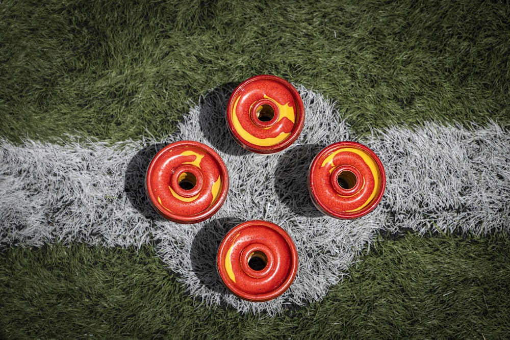 a group of red and yellow wheels on a green grass field