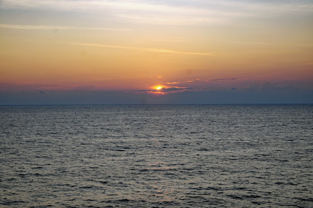 a sunset over a body of water