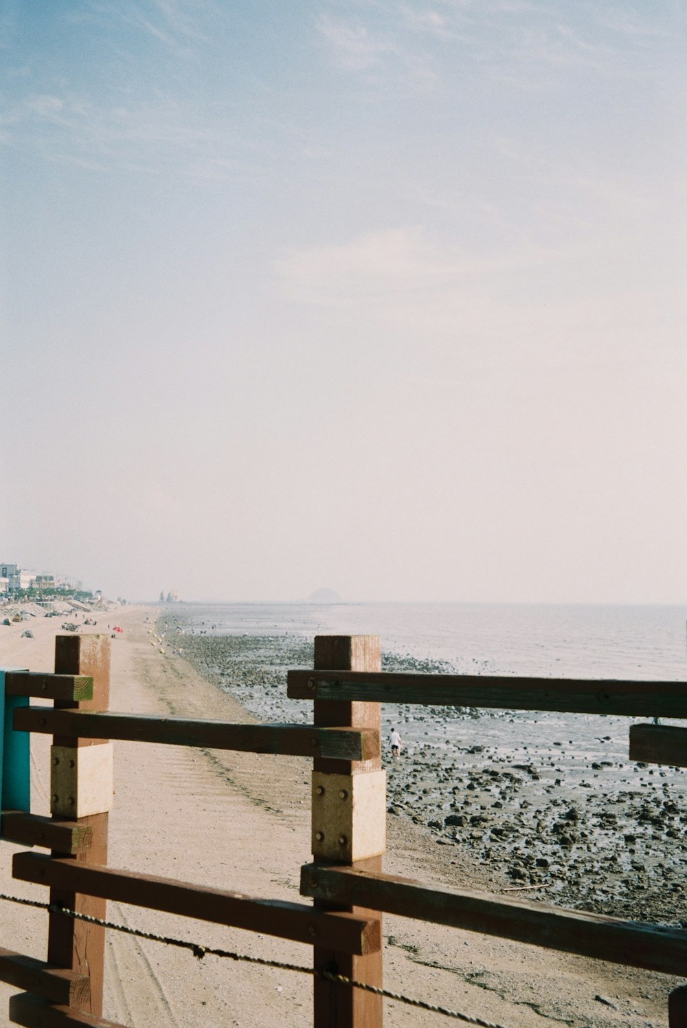 a wooden railing overlooking a beach
