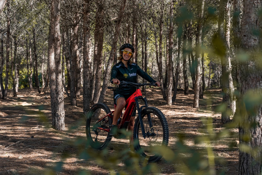 a man riding a bike in a forest