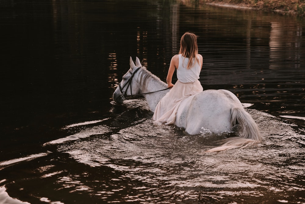 a person riding a horse in a river