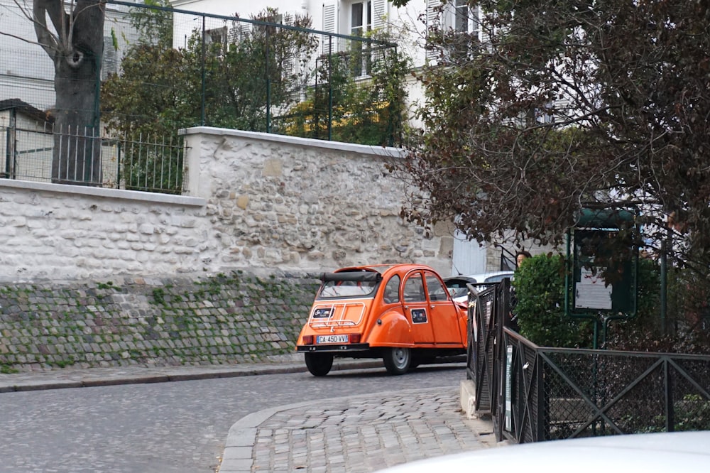 an orange car parked on a street
