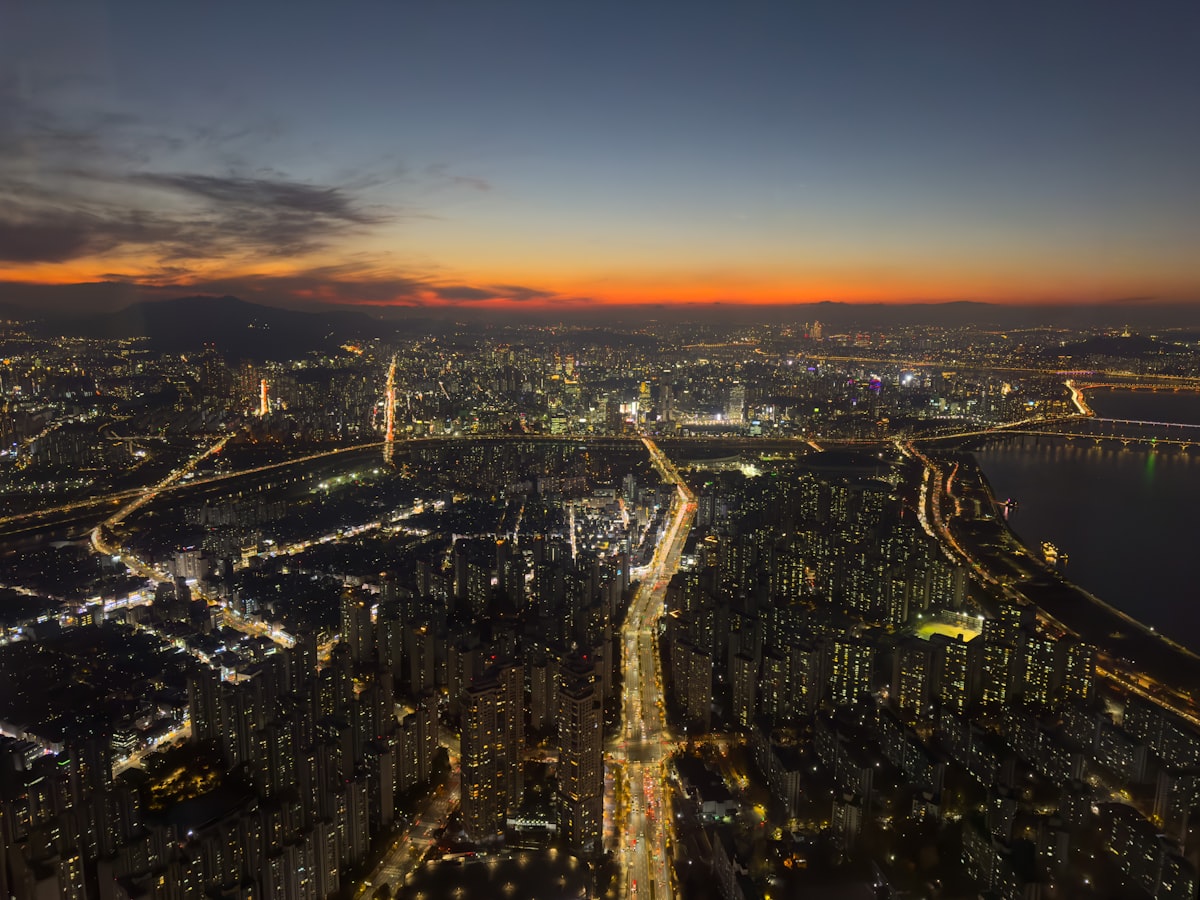 Seoul skyline lit up at night with N Seoul Tower in the distance