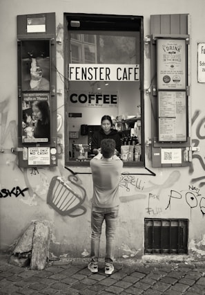 Sarina and Guido interacting with customers at their café.