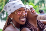 A candid moment of laughter shared between two sisters during a community event.