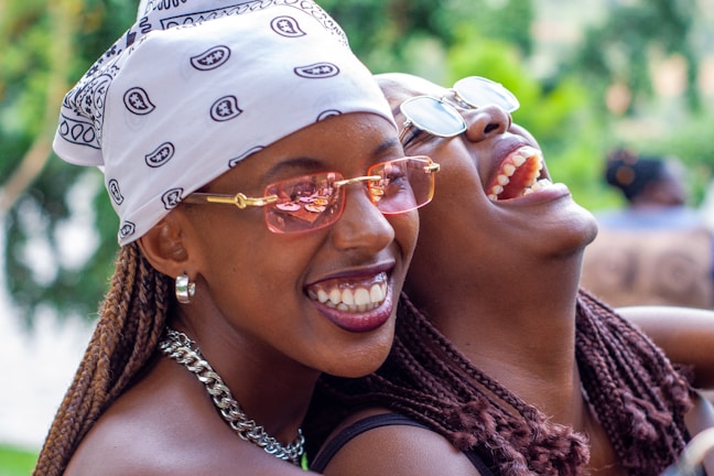 A candid moment of laughter shared between two sisters during a community event.