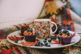 A cozy setup featuring bakebloom's cupcakes on a table.