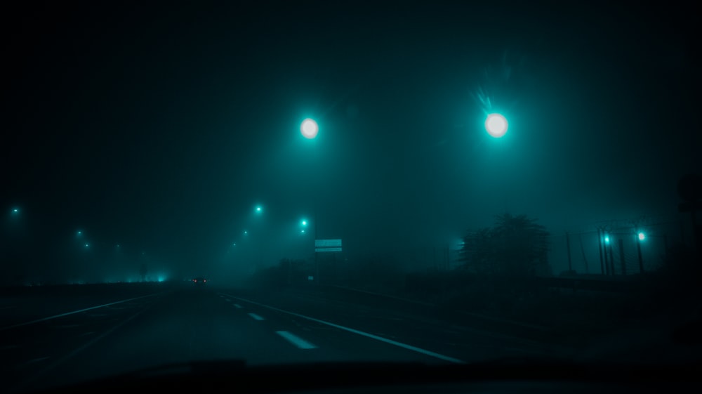 a road with street lights at night