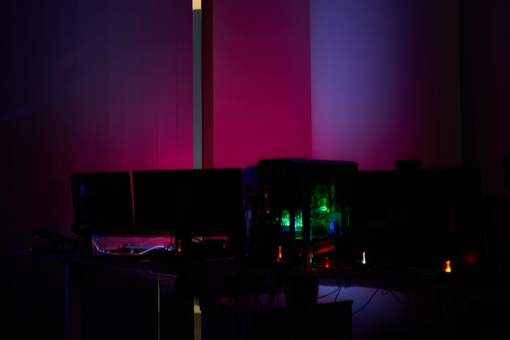 a room with a computer and a purple light