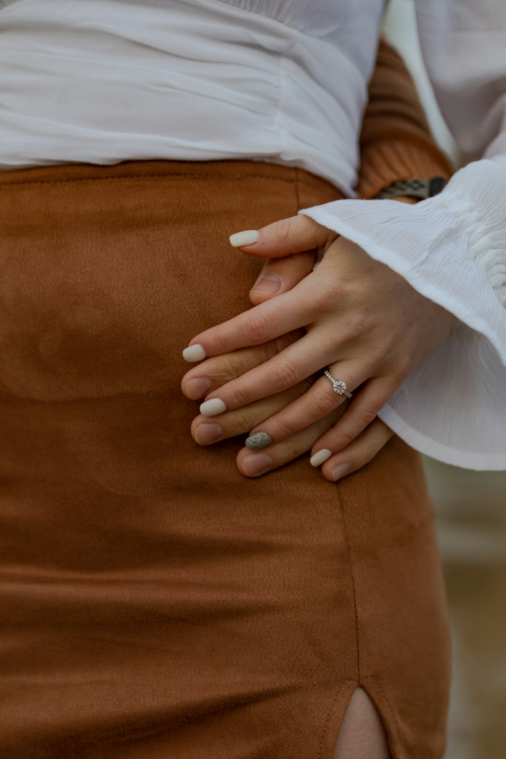 a person's hand with a ring on it