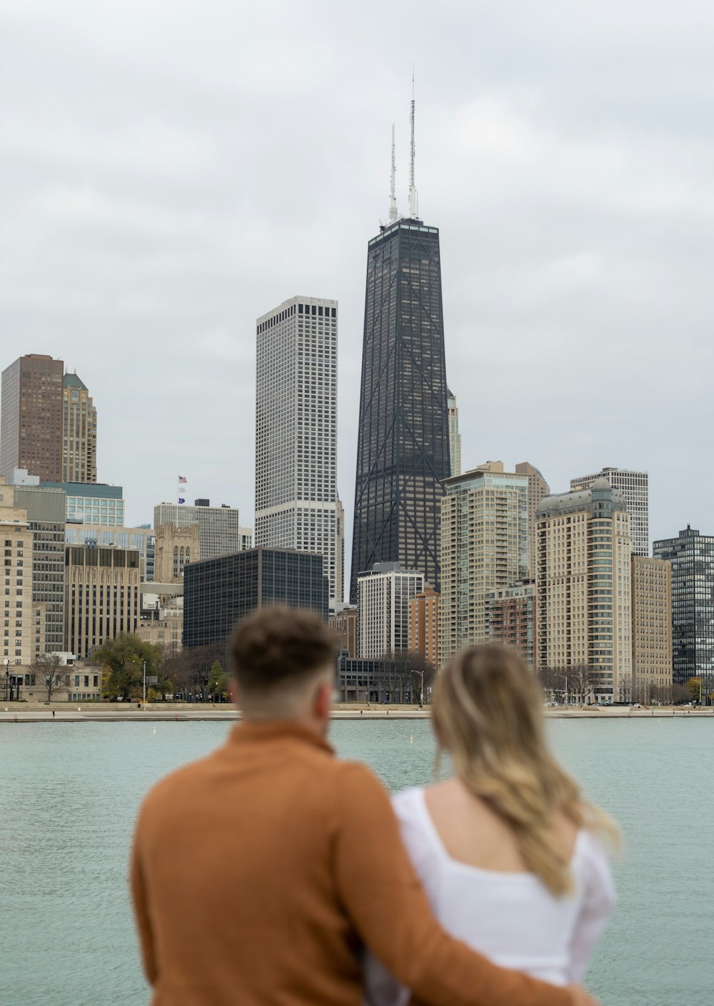 a man and woman looking at a city skyline