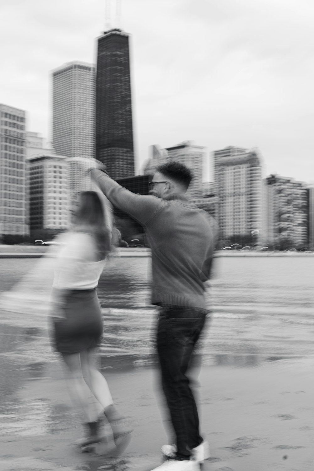 a man and a woman on a skateboard in a city