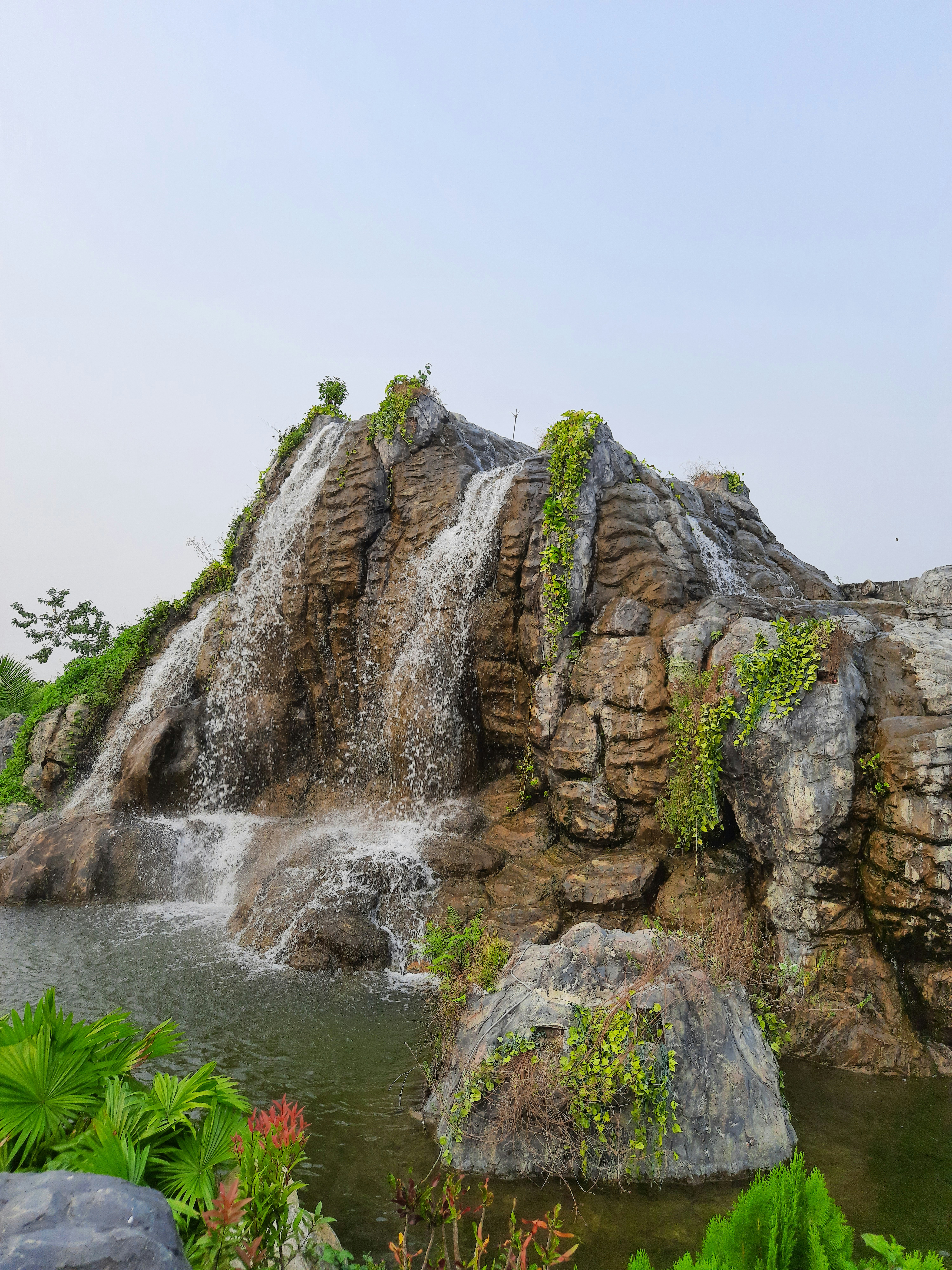 a waterfall over a rock cliff