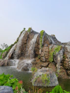 a waterfall over a rock cliff