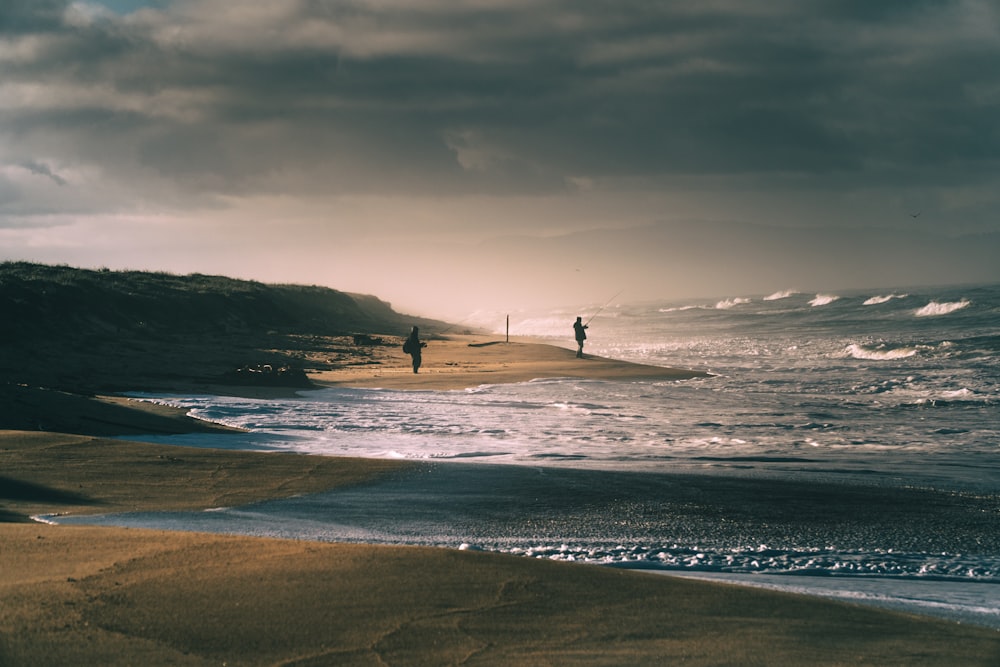 a couple of people surfing on the sea