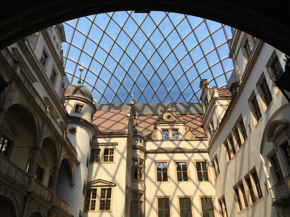 a view looking through a window at a building with a glass roof