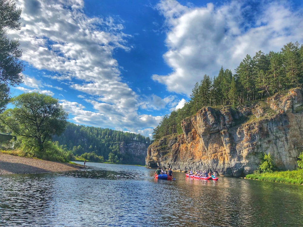 a group of people in a row boat on a river