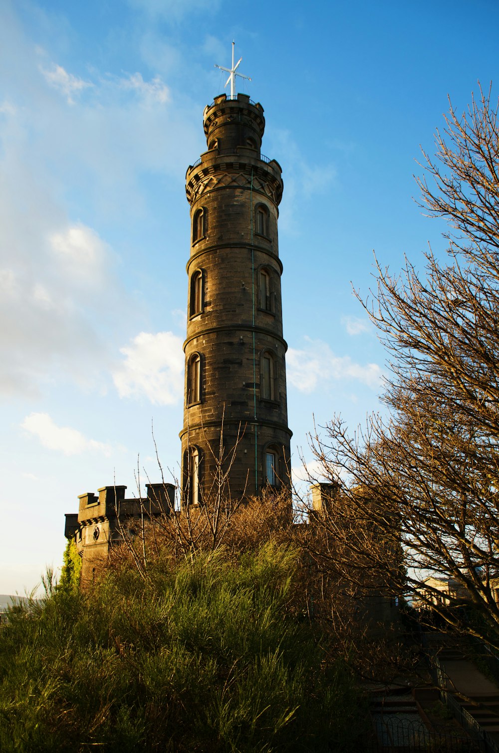 a tall tower with a cross on top