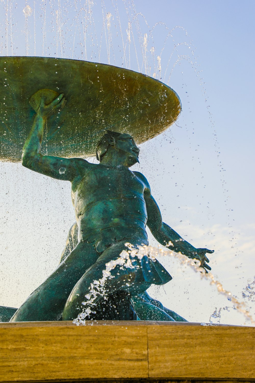 a statue of a person holding a fish