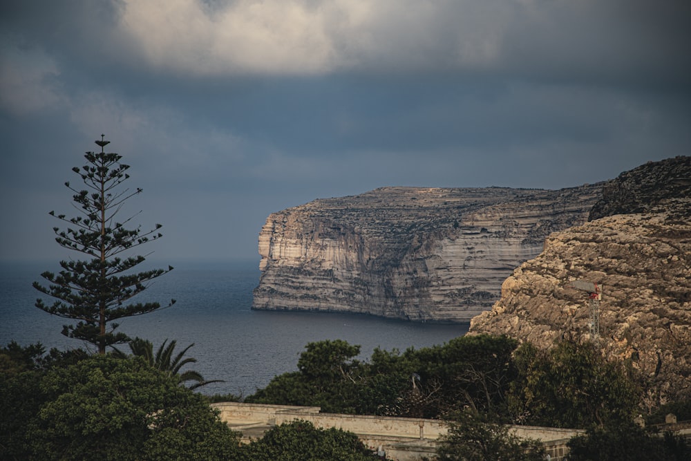 a cliff with a body of water below