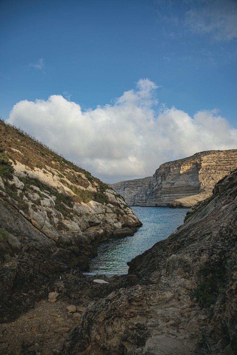 a body of water between rocky hills