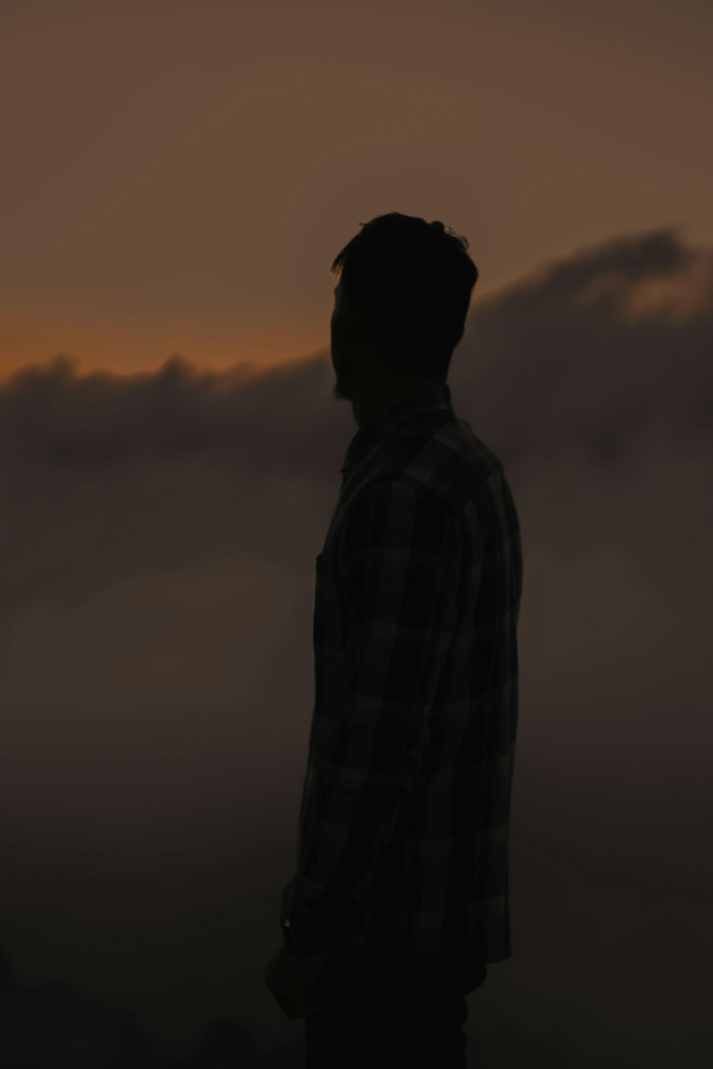 a person standing in front of a sunset