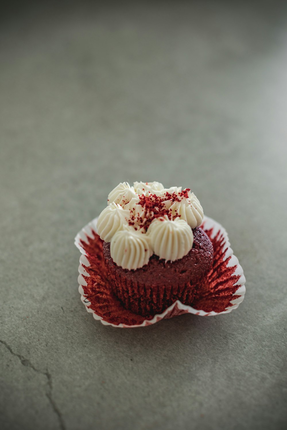 a cupcake with frosting and a red and white frosting