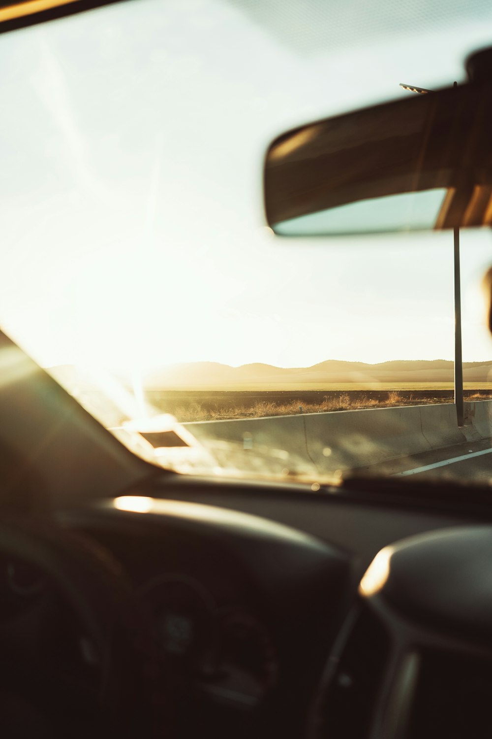 a view of a road from inside a car