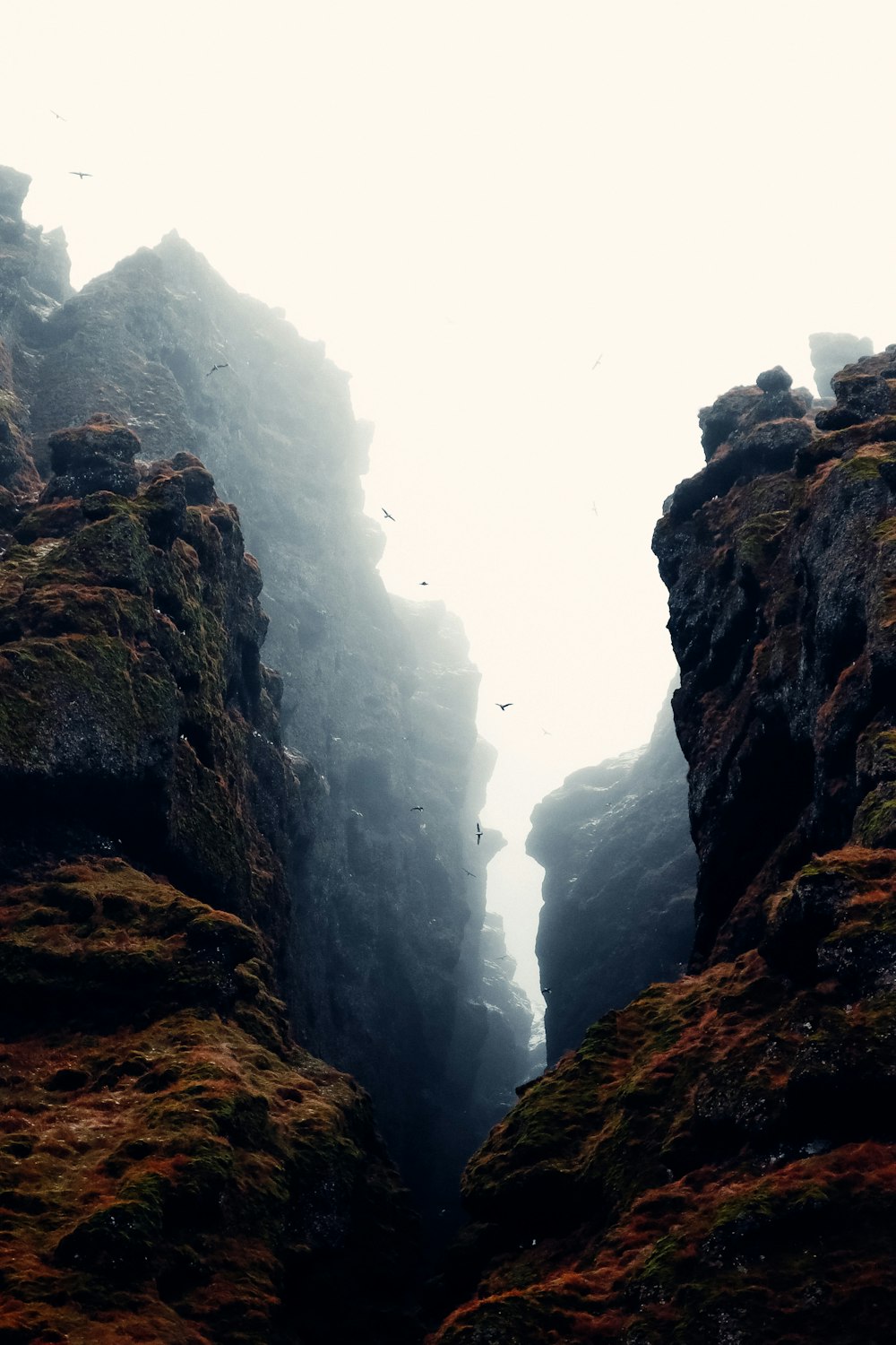 a cliff side with a waterfall