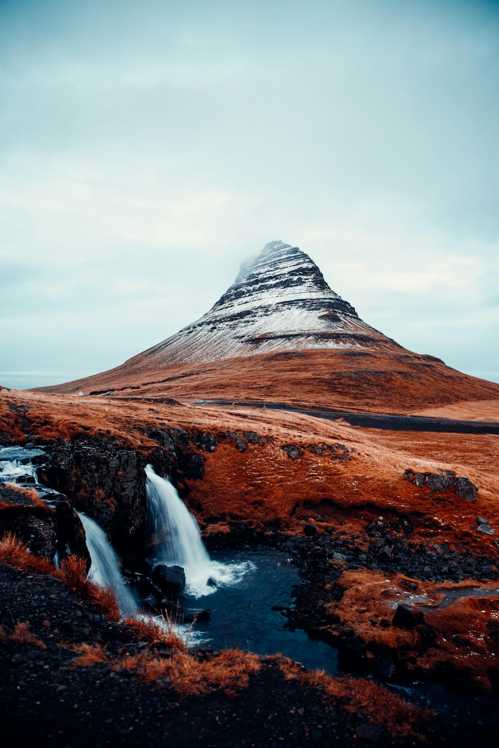 a mountain with a waterfall