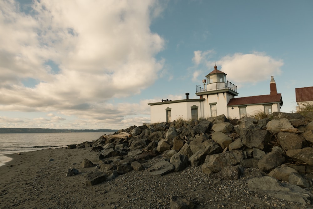 a rocky beach with a lighthouse