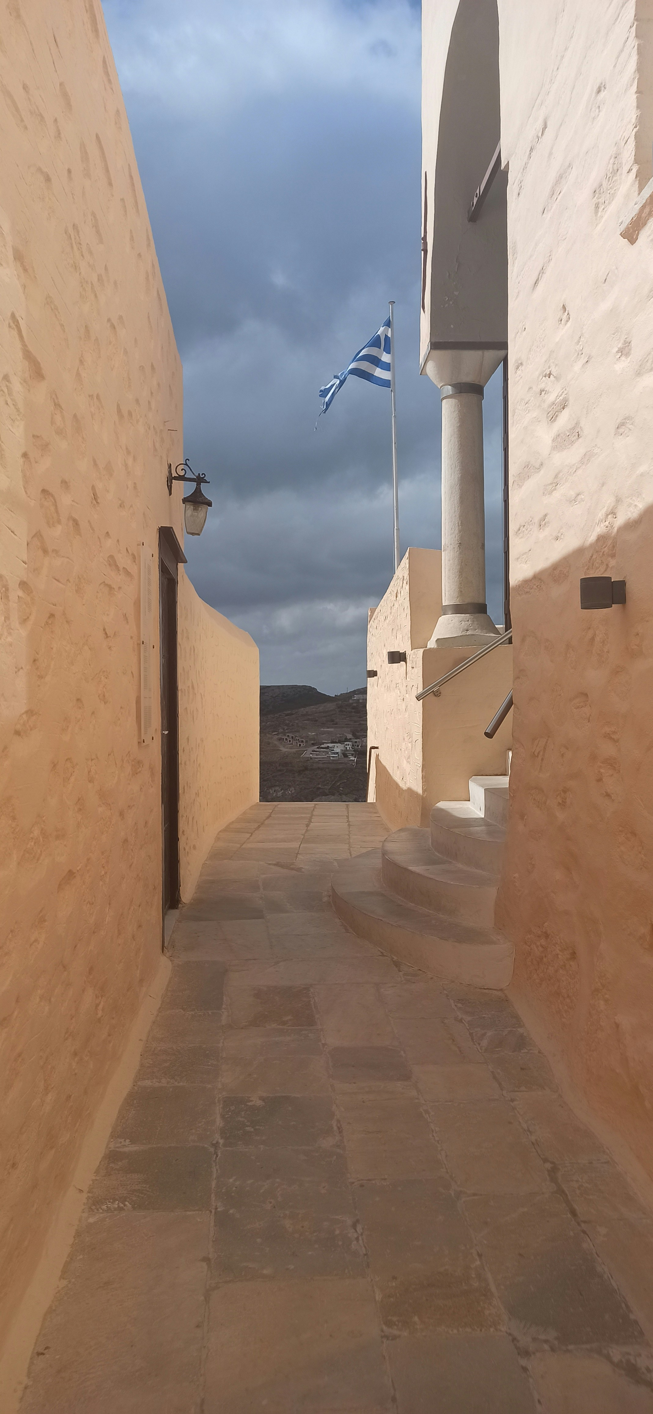 a stone walkway with a flag on it